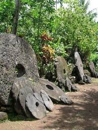 A row of rai stones of varying sizes lined up along a path on Yap.