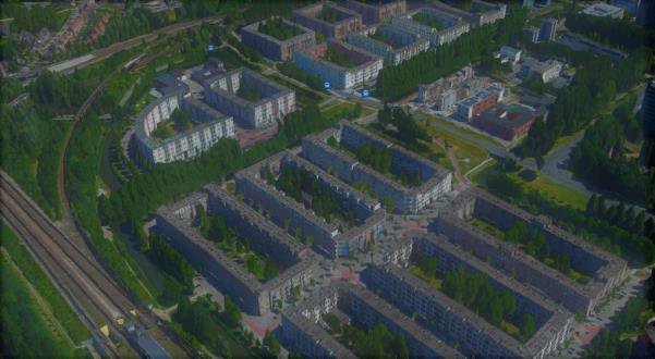 Aerial view of Venserpolder, a grid of mid-rise housing blocks with inner courtyards, bordered by railway lines.